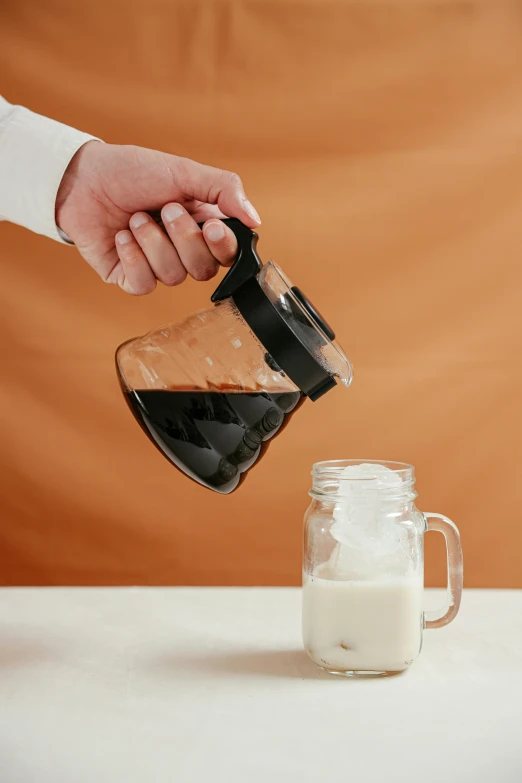 a person pouring milk into a mason jar, onyx, brown, alternate angle, akiman