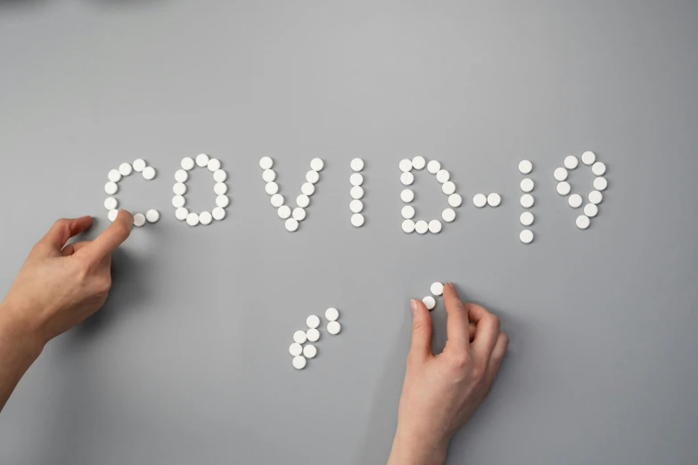 a person writing the word cough on a wall, trending on pexels, pills, cute coronavirus creatures, beads, silver