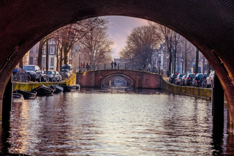 a bridge that is over a body of water, by Jan Tengnagel, pexels contest winner, art nouveau, jan vermeer, archway, thumbnail, amsterdam