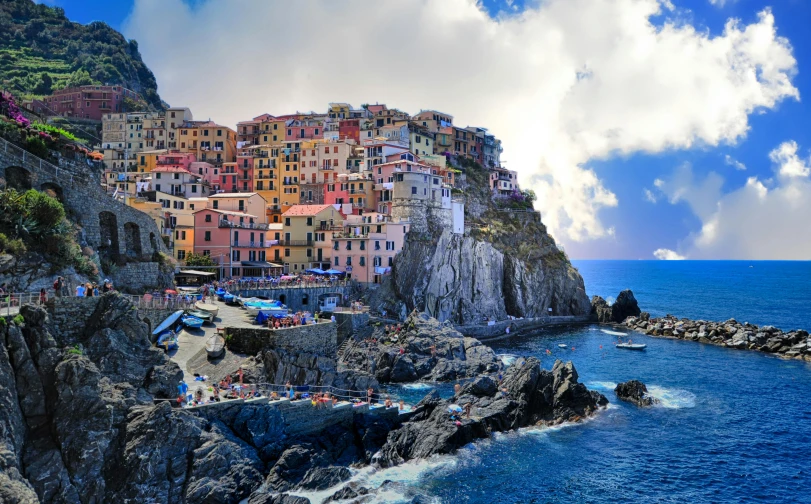 a group of buildings sitting on top of a cliff next to the ocean, pexels contest winner, renaissance, colorful caparisons, vouge italy, profile image, bulgari