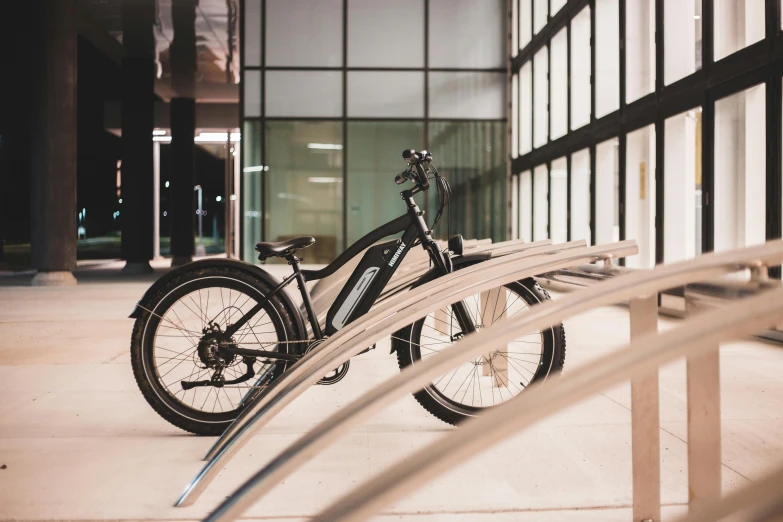 a bicycle parked in front of a building, octane fender, steel archways, profile image, electric