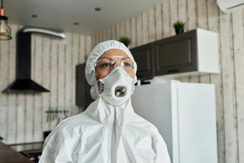 a woman in a protective suit standing in a kitchen, a portrait, pexels contest winner, plasticien, avatar image, bag - valve mask, white, ultra realistic