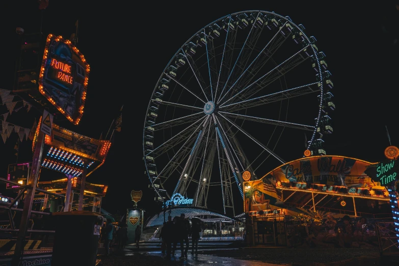 people standing in front of a ferris wheel at night, pexels contest winner, amusement park buildings, thumbnail, night time footage, profile image