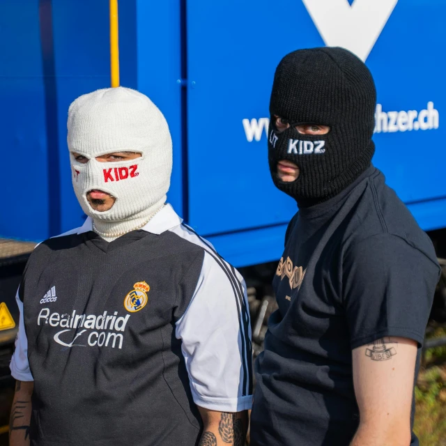 a couple of men standing next to each other, by Werner Gutzeit, reddit, graffiti, balaclava mask, football hooligans, off white, krenz c