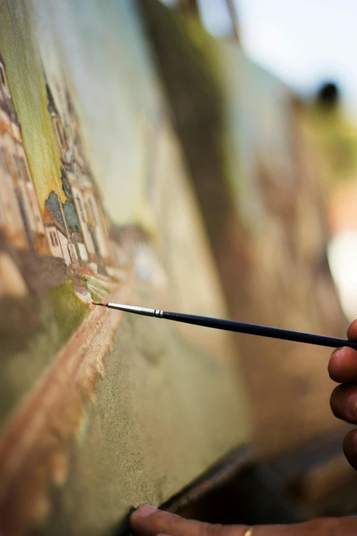 a close up of a person painting on a canvas, a detailed painting, detailed surroundings, holding a paintbrush, brown, ilustration