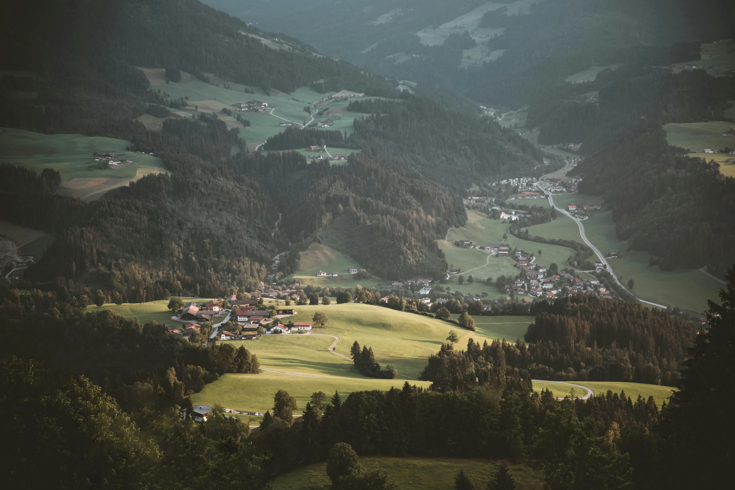 a view of a small town in the mountains, by Sebastian Spreng, pexels contest winner, renaissance, lush forest in valley below, meadows, shot on hasselblad, low light