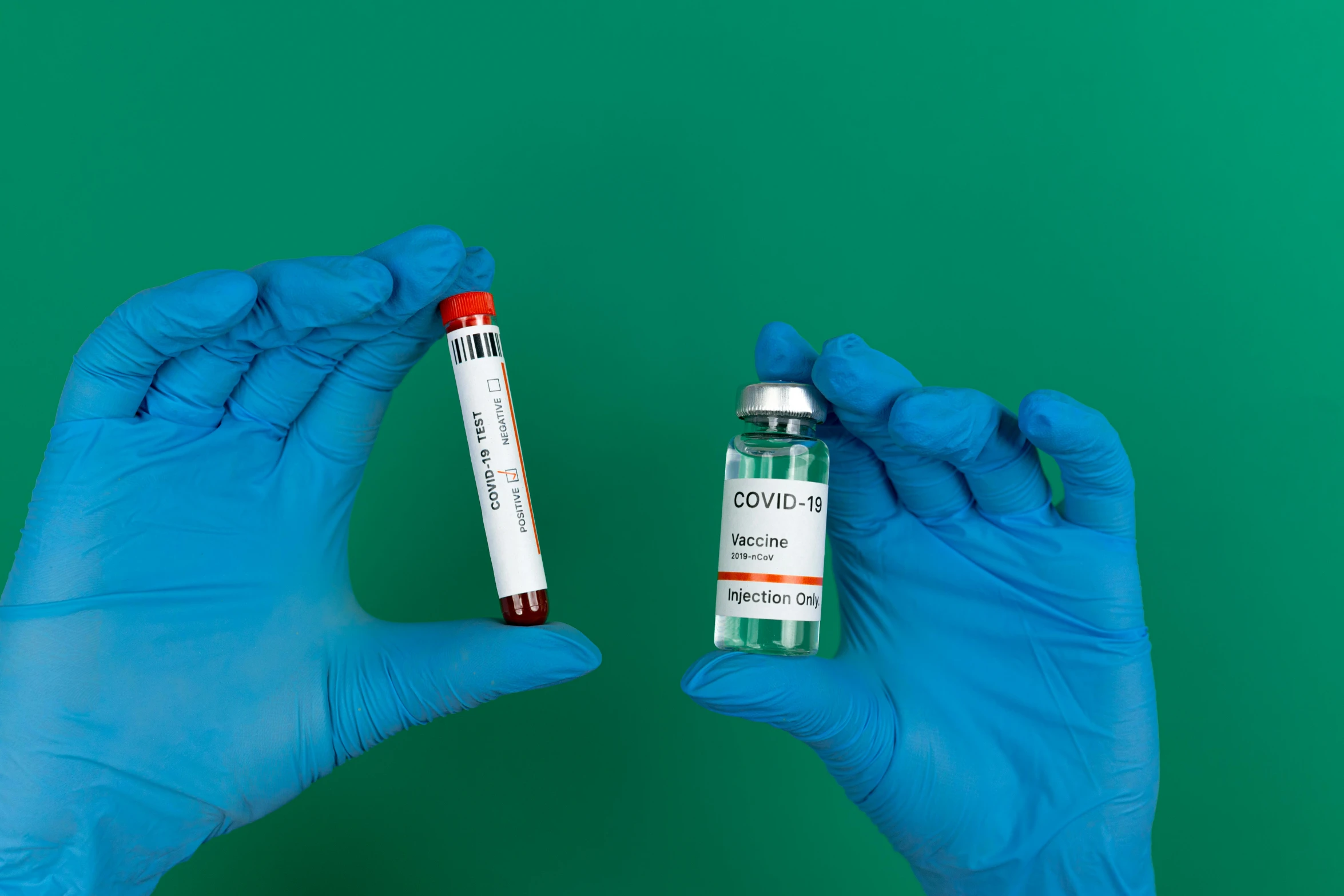 a person in blue gloves holding a tube of blood, teal and orange, size difference, coronavirus, press shot