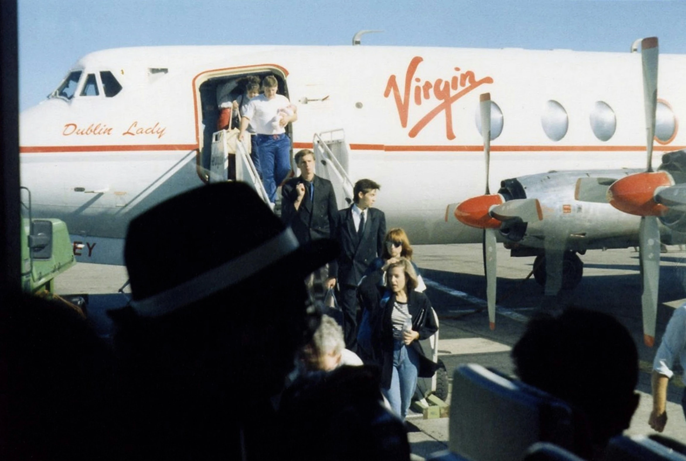 a large jetliner sitting on top of an airport tarmac, a colorized photo, by John Michael Wright, visual art, martin parr, lady diana, royal commission, with many travelers