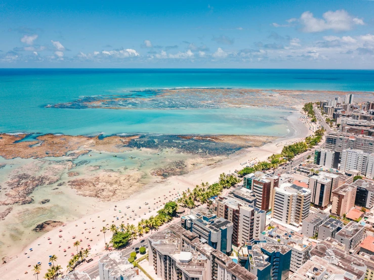 an aerial view of the beach and ocean, by Felipe Seade, pexels contest winner, hurufiyya, outdoors tropical cityscape, thumbnail, high definition image