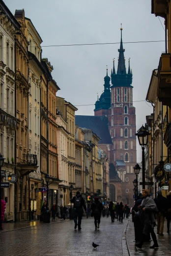 a group of people walking down a street next to tall buildings, by Adam Marczyński, pexels contest winner, renaissance, black domes and spires, zdzislaw bekinski, square, seasonal