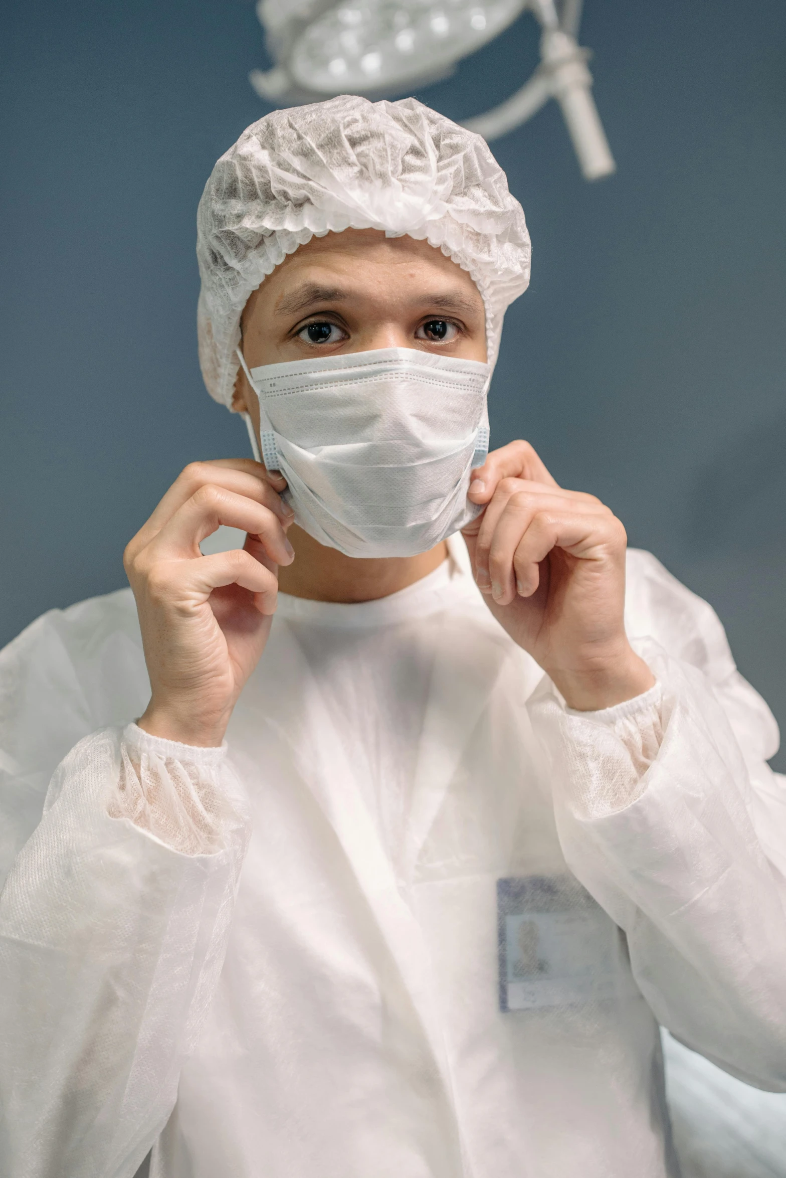 a close up of a person wearing a surgical mask, an album cover, by Adam Marczyński, shutterstock, happening, wearing a labcoat, clean room, engineering, ruffles