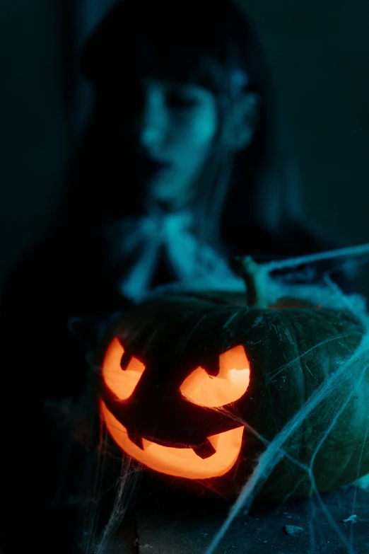 a halloween pumpkin sitting on top of a table, by Elsa Bleda, pexels contest winner, portrait of sadako of the ring, castlevania witch, middle close up shot, ( ( theatrical ) )