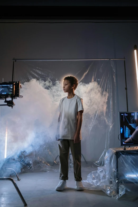 a man that is standing in front of a camera, a picture, light over boy, creative vfx, promo image, young boy