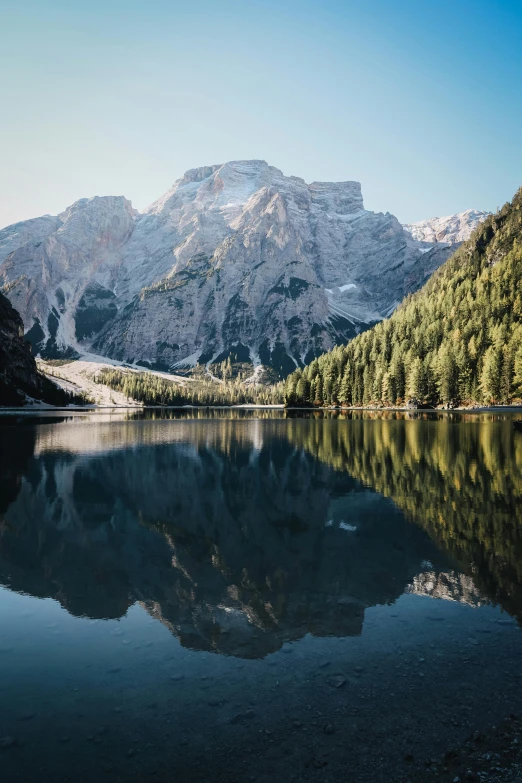 a body of water with mountains in the background, pexels contest winner, dolomites in background, trees reflecting on the lake, chasm, full frame image