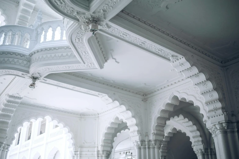 a couple of people that are standing in a building, inspired by Frederick Lord Leighton, unsplash contest winner, rococo, indian temple, detailed white, pointed arches, view from ground level