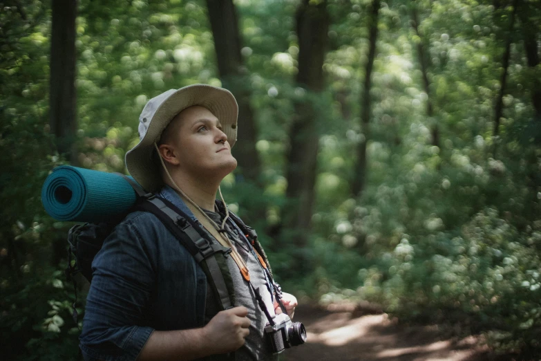 a man standing in the woods with a backpack on his back, a portrait, pexels contest winner, renaissance, 4 k cinematic still, profile picture 1024px, looking up at camera, scout boy