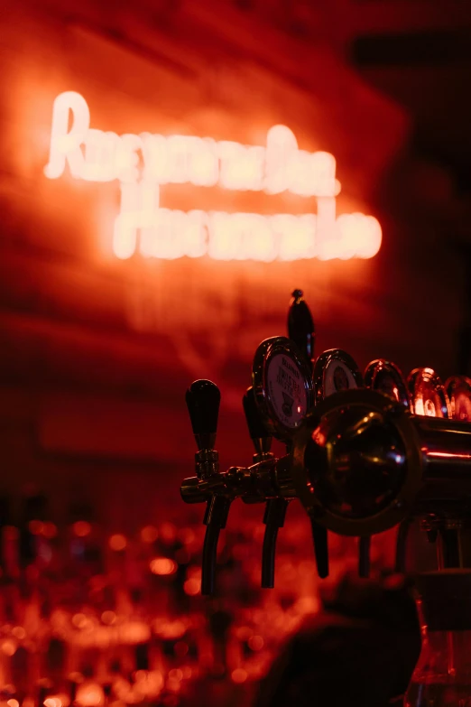 a close up of a beer tap with a neon sign in the background, by Jesper Knudsen, happening, kramskoi 4 k, multiple stories, concert, crimson themed