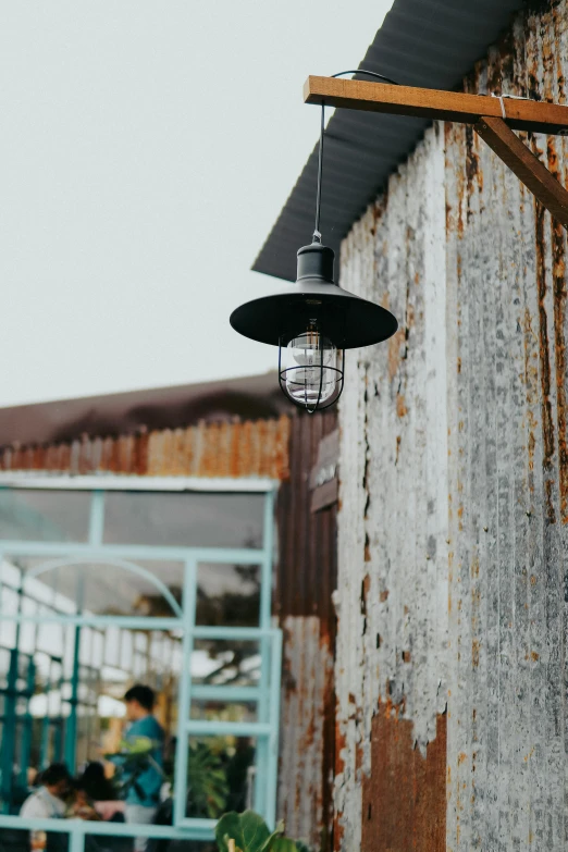 a light hanging from the side of a building, rustic setting, 2019 trending photo, industrial setting, exterior shot