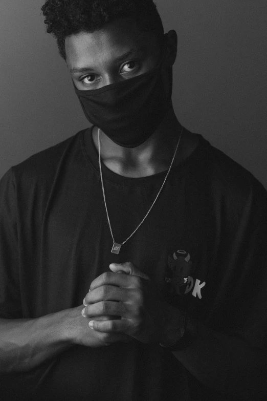 a black and white photo of a man wearing a mask, by Bascove, handsome hip hop young black man, black cloth, portrait of an ai, white bandages on fists