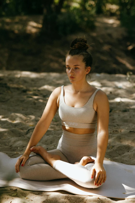 a woman sitting in the middle of a yoga pose, unsplash, renaissance, sport bra and shirt, tan, lush surroundings, teenage girl