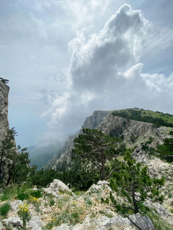 a person riding a bike on top of a mountain, capri coast, grey clouds, fierce - looking, slide show