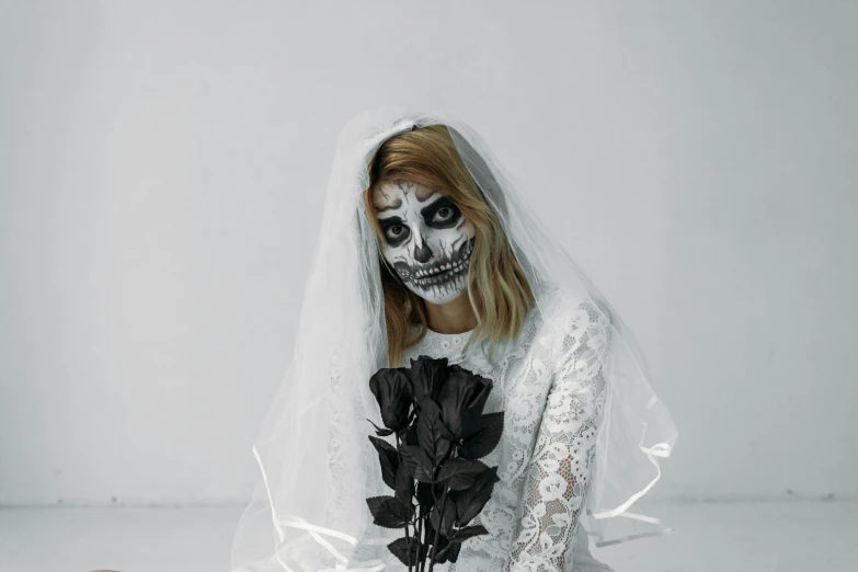 a woman in a wedding dress sitting on the floor, inspired by Elsa Bleda, pexels contest winner, gothic art, full skull shaped face cover, with a white background, diverse costumes, bouquet