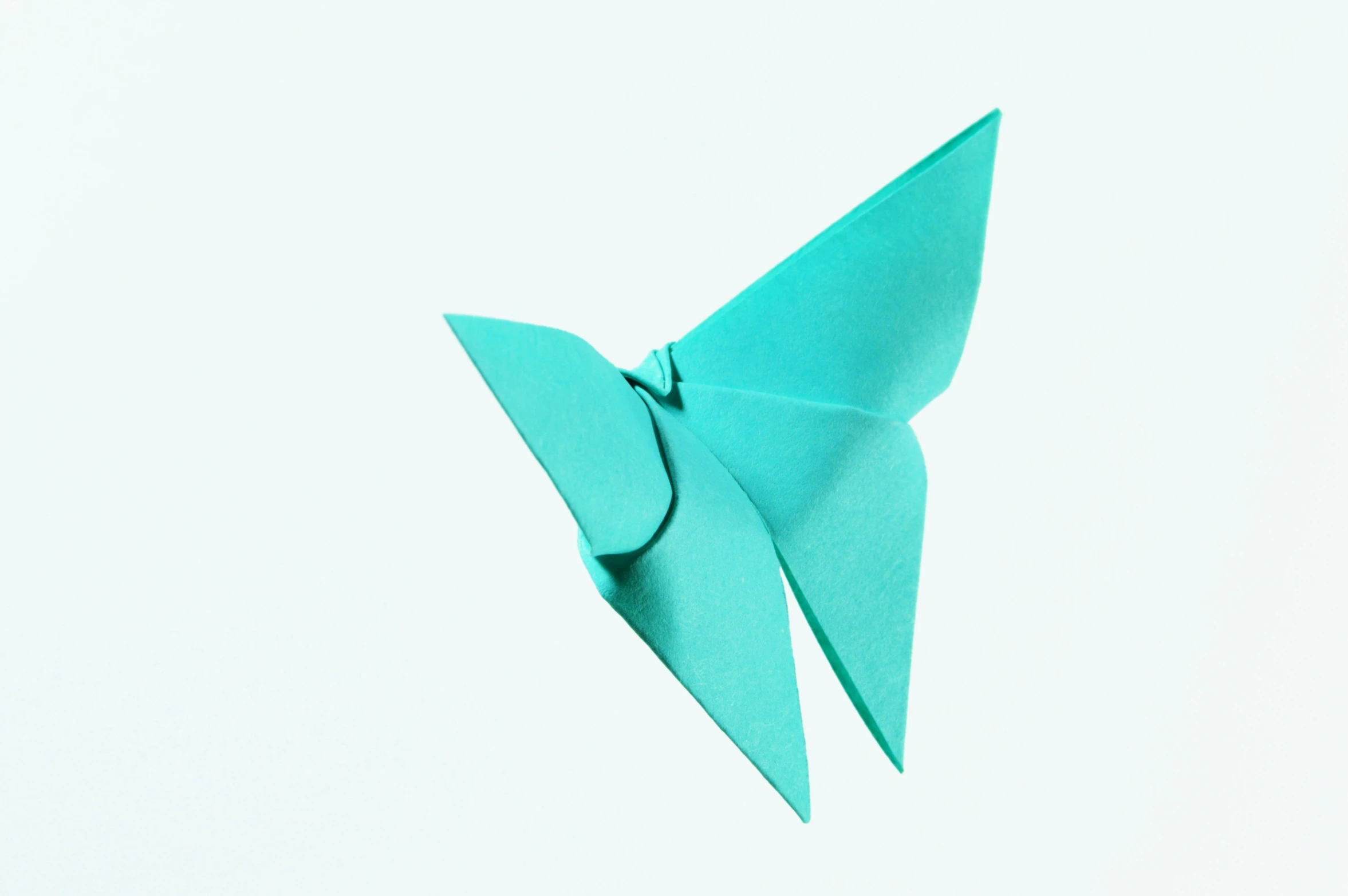 a blue origami bird flying in the sky, an album cover, inspired by Masamitsu Ōta, trending on unsplash, hurufiyya, butterfly squid, seafoam green, 1995, issey miyake