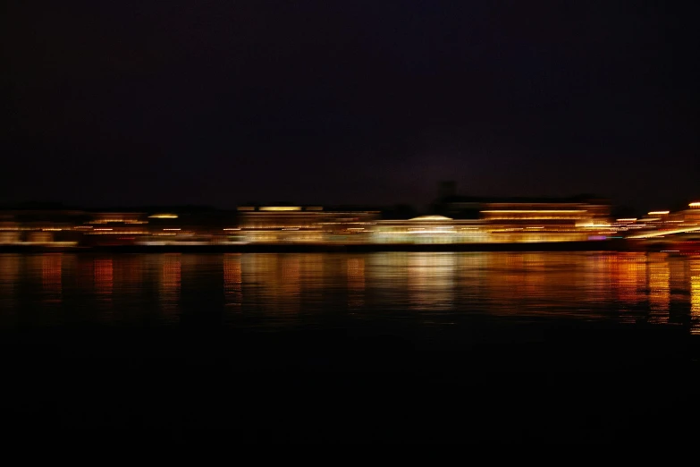 a large body of water next to a city at night, by Jan Rustem, pexels contest winner, minimalism, zoom blur, ships, panoramic, floating palace