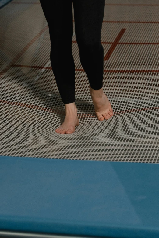 a woman standing on a mat in a gym, inspired by Victorine Foot, dribble, checkerboard pattern underwater, zoomed in, draincore, polymesh