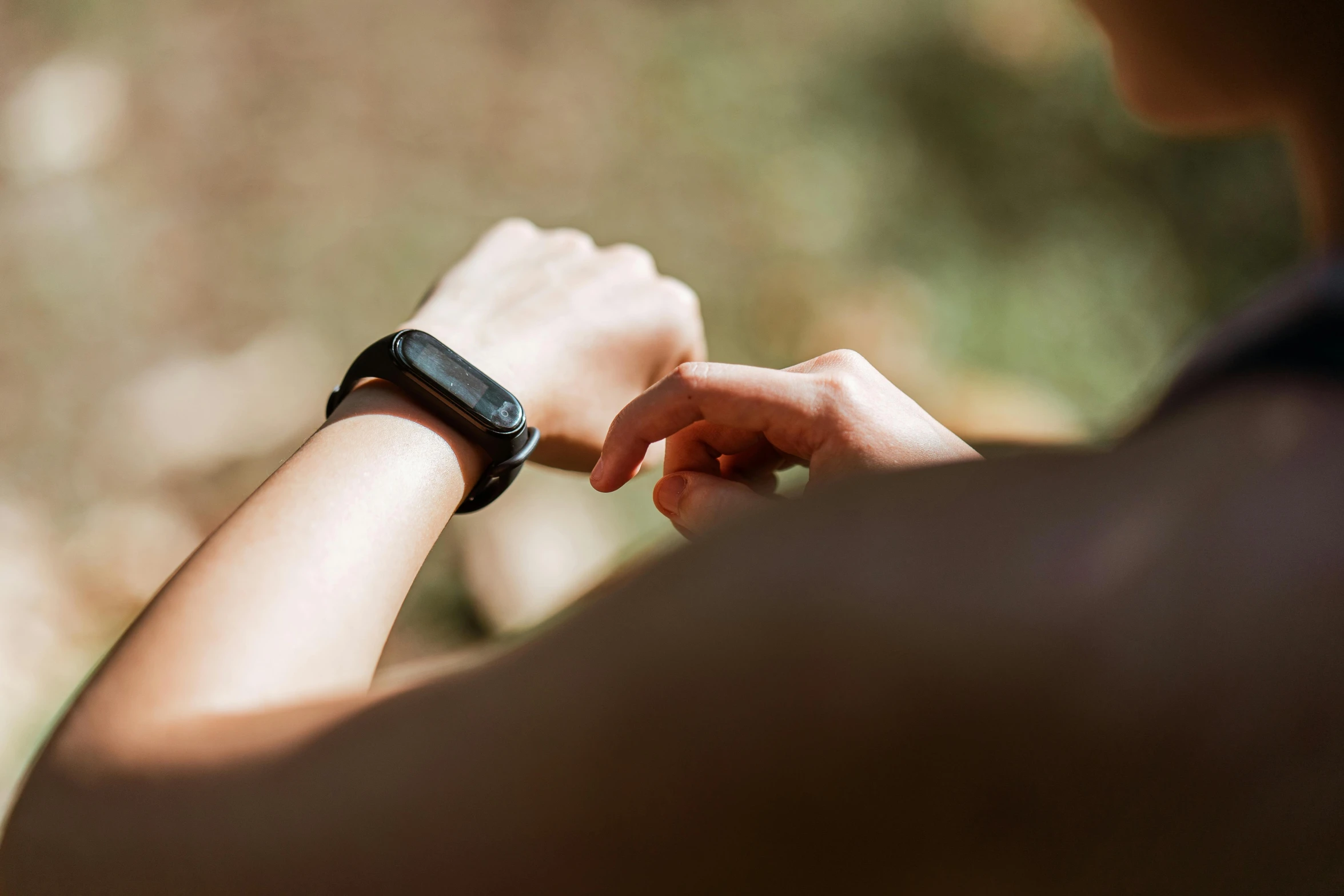 a close up of a person holding a smart watch, by Adam Marczyński, trending on pexels, lush surroundings, looking left, thumbnail, trecking