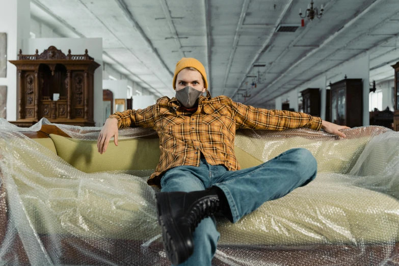 a man sitting on a couch covered in plastic, trending on pexels, hyperrealism, in warehouse, avatar image, lumberjack, face covered