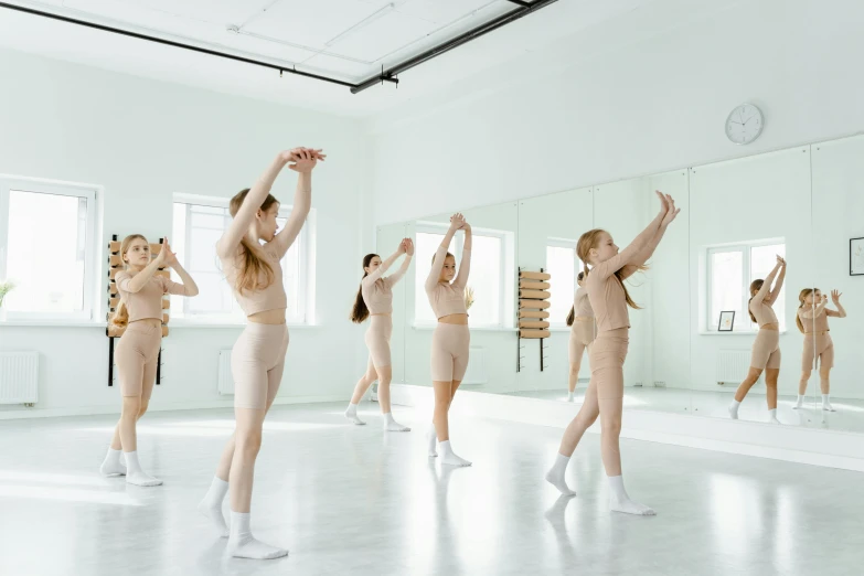 a group of women standing in a dance studio, by Emma Andijewska, trending on pexels, arabesque, kid, in white room, thumbnail