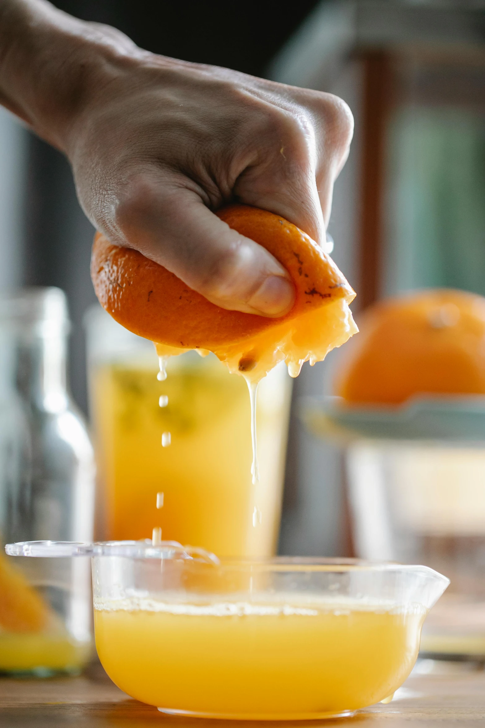 a person squeezing an orange into a bowl, bartending, zoomed in, thumbnail, uncrop