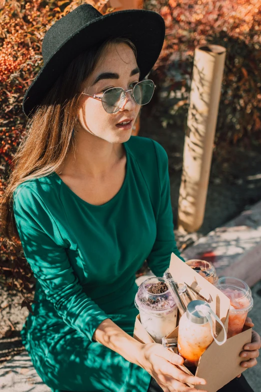 a woman sitting on a bench holding a box of food, pexels contest winner, renaissance, woman with rose tinted glasses, casual green clothing, people outside eating meals, profile image