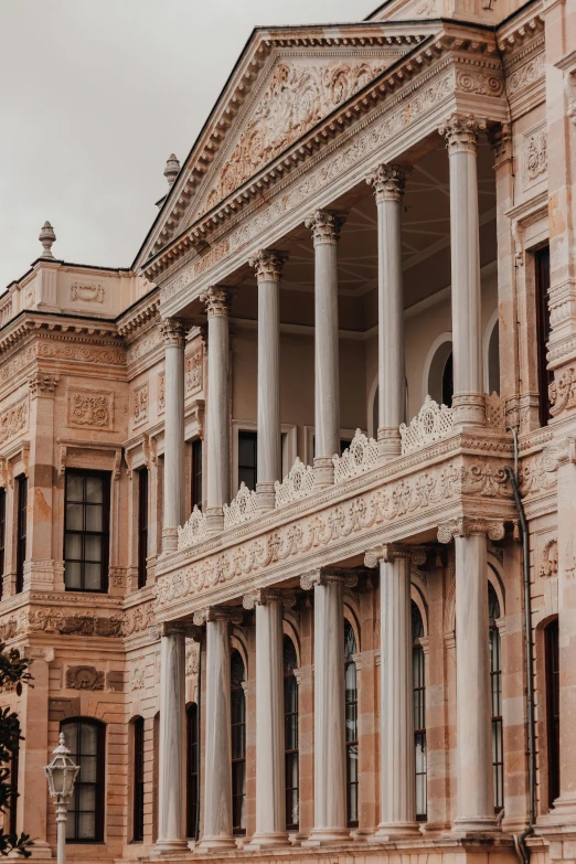 a couple of people that are standing in front of a building, inspired by Mihály Munkácsy, pexels contest winner, neoclassicism, brown and pink color scheme, turkey, vast library, square