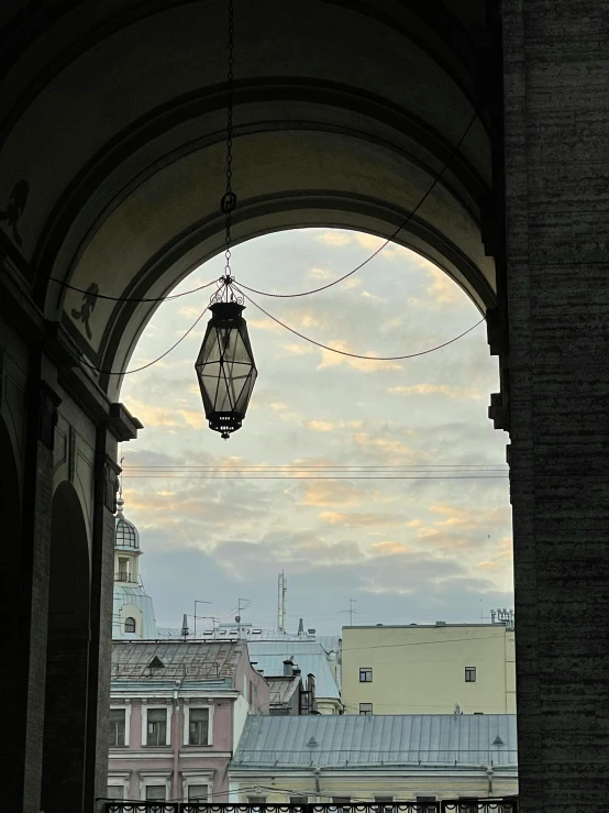 a street light hanging from the side of a building, inspired by Bernardo Bellotto, pexels contest winner, renaissance, high arched ceiling, view from inside, profile image, photo on iphone