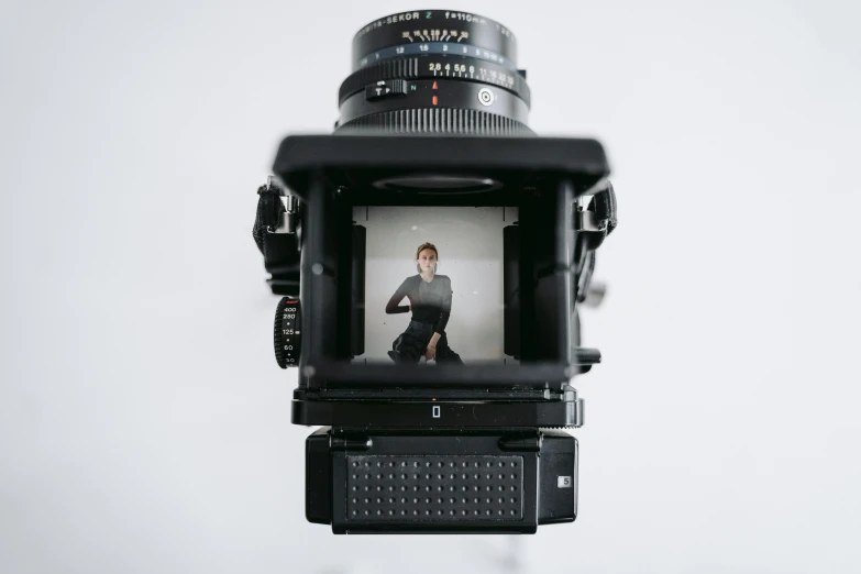 a close up of a camera with a person taking a picture, a picture, by Tobias Stimmer, unsplash, hyperrealism, large format camera, full body within frame, looking directly at the viewer, medical photography