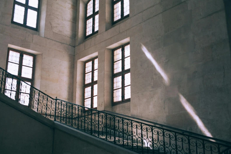 a man riding a skateboard up the side of a flight of stairs, a marble sculpture, inspired by François Barraud, pexels contest winner, light and space, photo of a beautiful window, dusty library, rows of windows lit internally, soft sunlight dappling