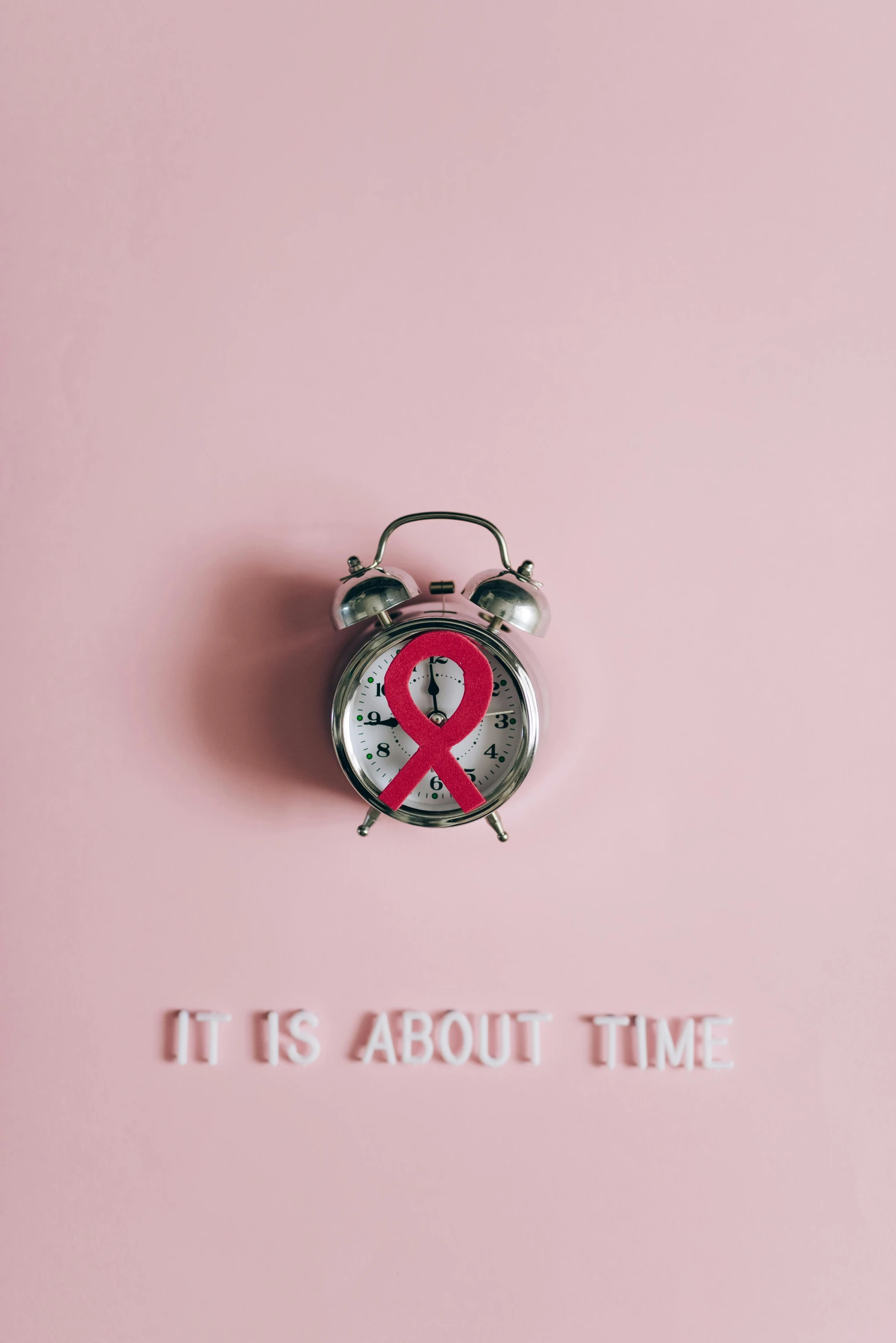 an alarm clock sitting on top of a pink surface, red ribbon, tumours, ilustration, - i