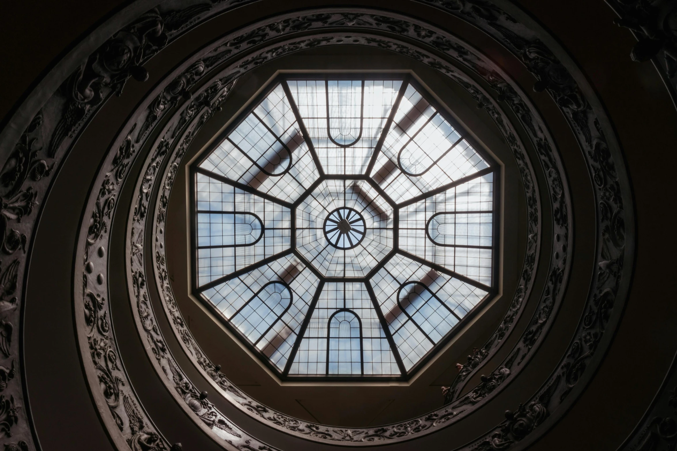 a spiral staircase with a skylight above it, by Giuseppe Avanzi, pexels contest winner, art nouveau, hexagonal shaped, maurizio cattelan, ornamental halo, top lid