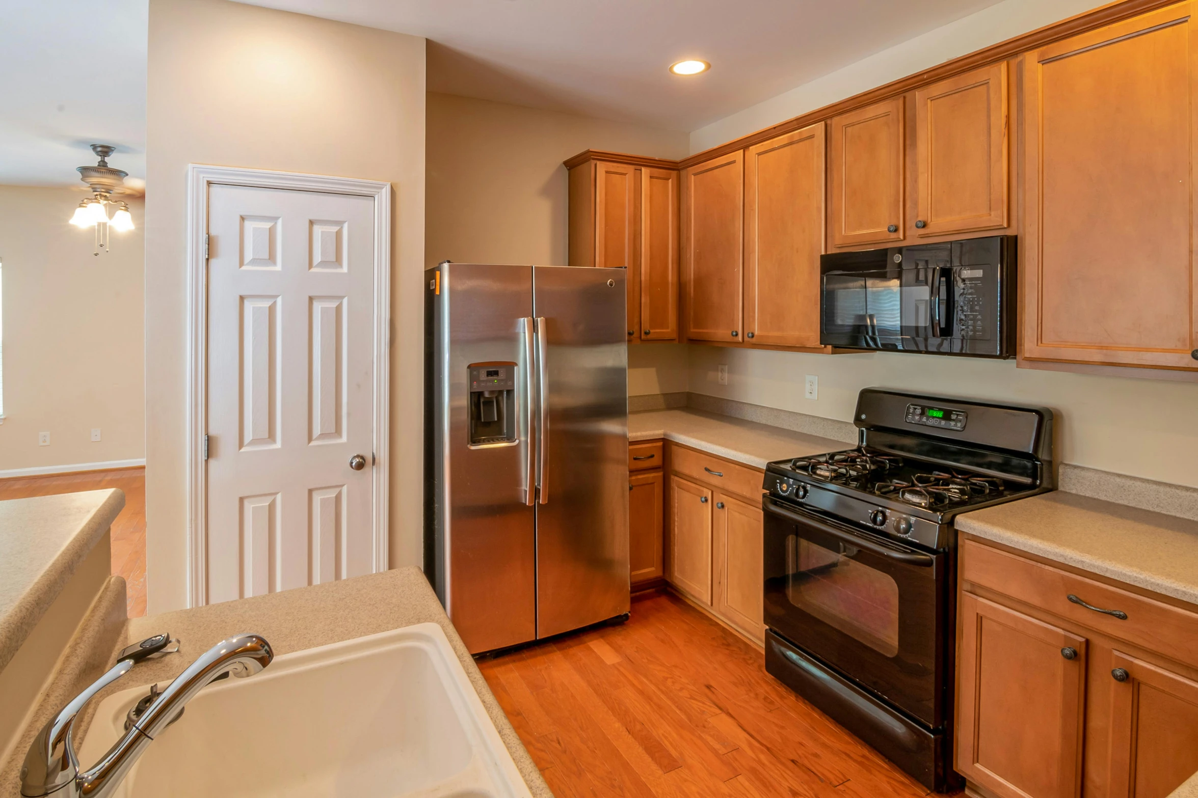 a kitchen with wooden cabinets and stainless steel appliances, by Carey Morris, unsplash, wide high angle view, fan favorite, max dennison, bottom angle