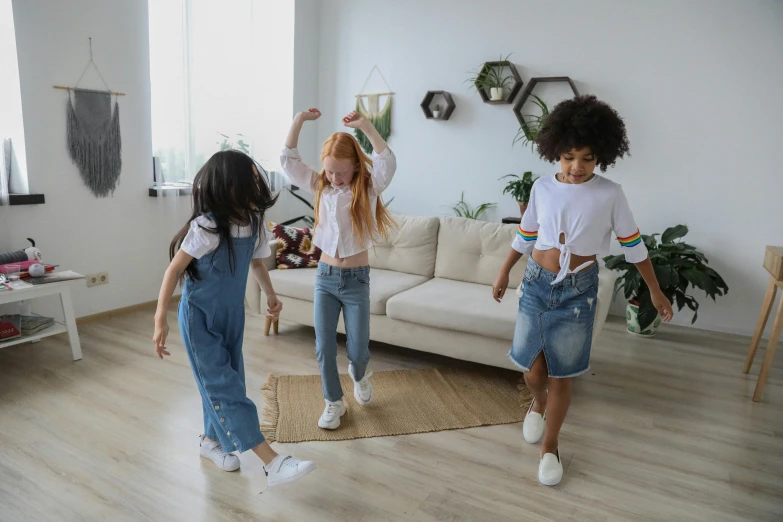 a group of young girls standing on top of a hard wood floor, pexels contest winner, dancing, playing games, wearing denim, drawing for children