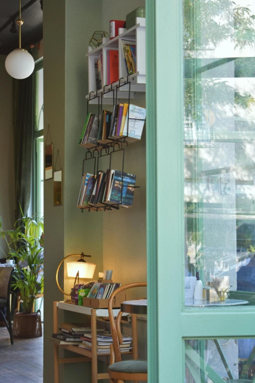 a living room filled with furniture and a book shelf, unsplash, conceptual art, inside a french cafe, green terrace, cables hanging, vignette of windowsill