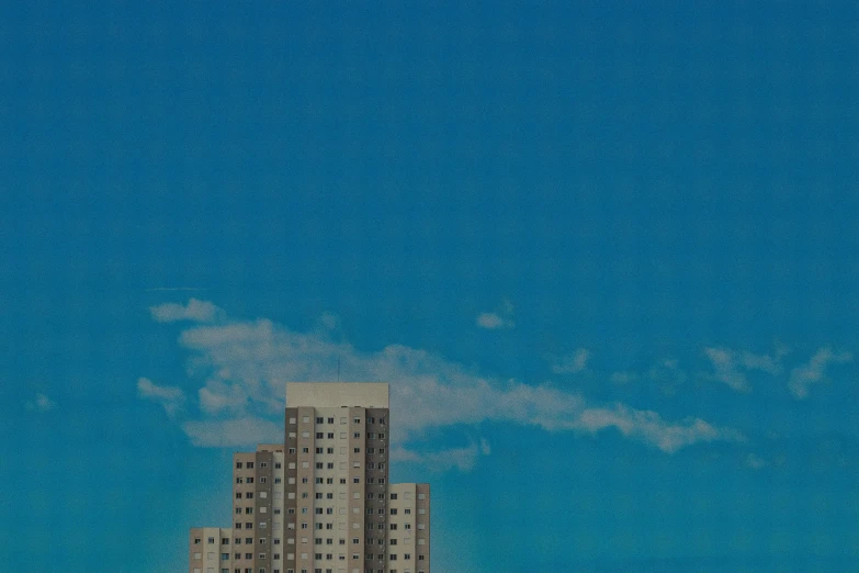 a couple of tall buildings sitting on top of a lush green field, an album cover, unsplash, brutalism, sky blue, soviet apartment building, cloudless blue sky, computer wallpaper