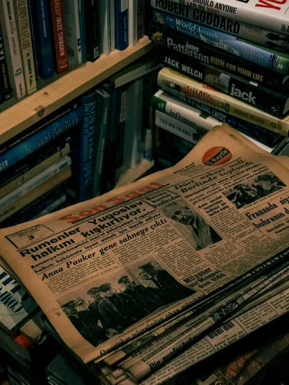 a pile of newspapers sitting on top of a pile of books, a picture, by Niko Henrichon, pexels contest winner, old magazine cover without text, grainy photo, bookshelves, vintage sci - fi