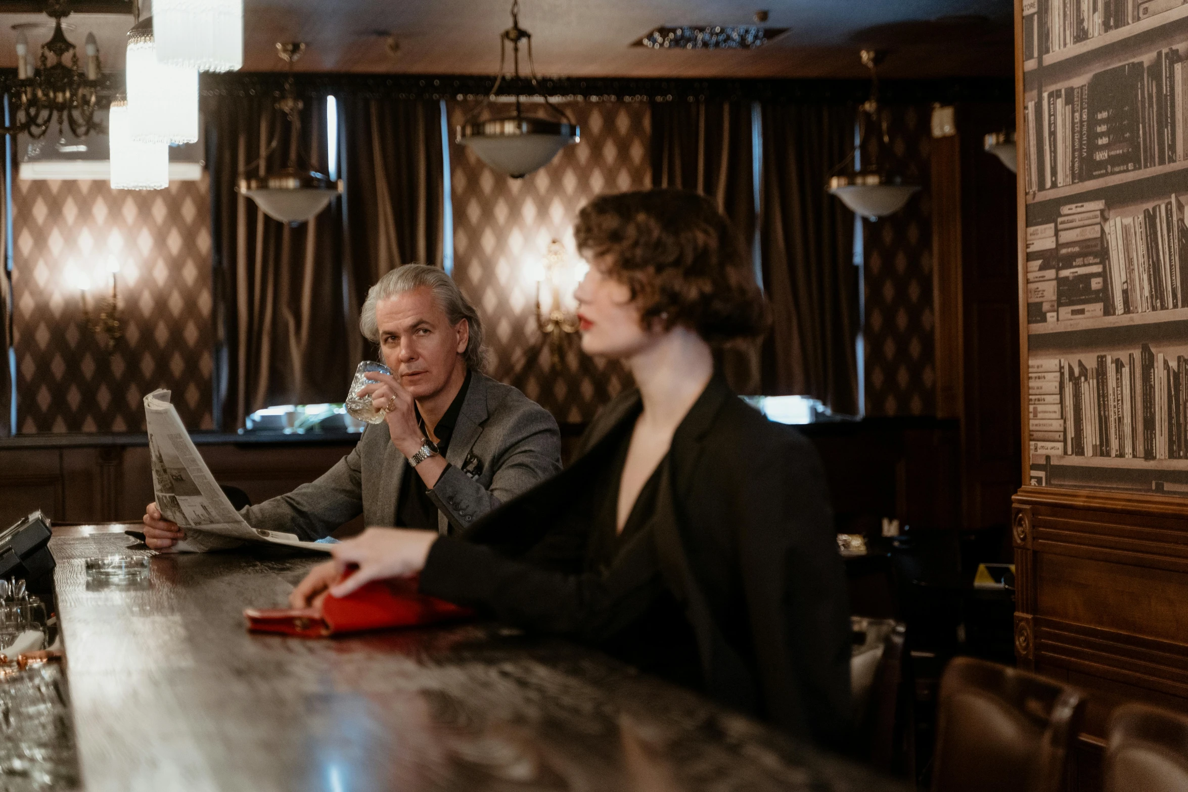 a man and a woman sitting at a bar, unsplash, fantastic realism, bill nye as james bond, man reading newspaper in a bar, ignant, upscale photo