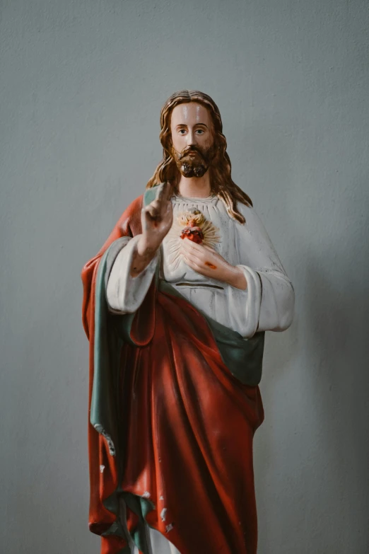 a statue of jesus holding a piece of bread, a statue, by Everett Warner, trending on unsplash, fine art, hearts, finely painted, reliquary, 155 cm tall