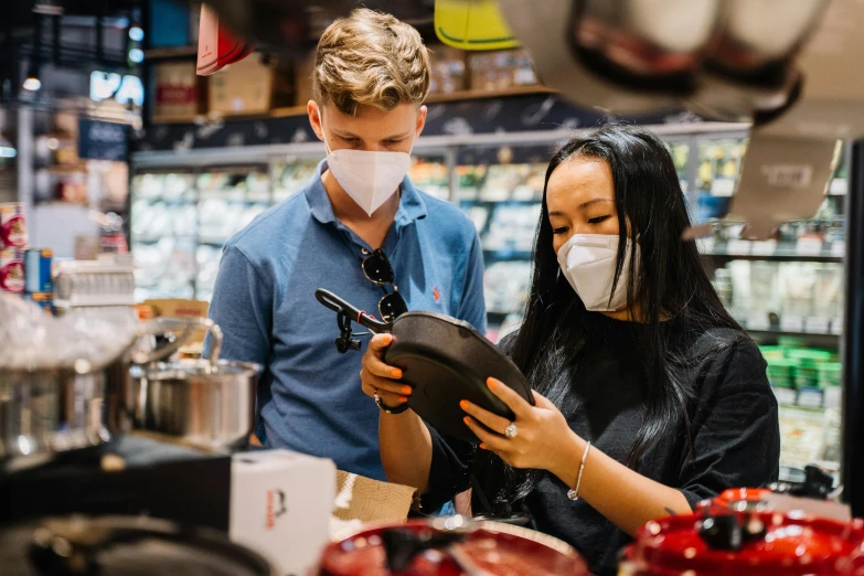 a couple of people that are standing in a store, pexels contest winner, renaissance, wearing facemask, ready to eat, lachlan bailey, guide