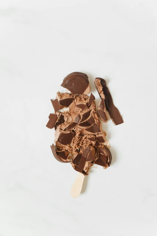 a chocolate covered ice cream on a stick, birch, fan favorite, crisp edges, overflowing