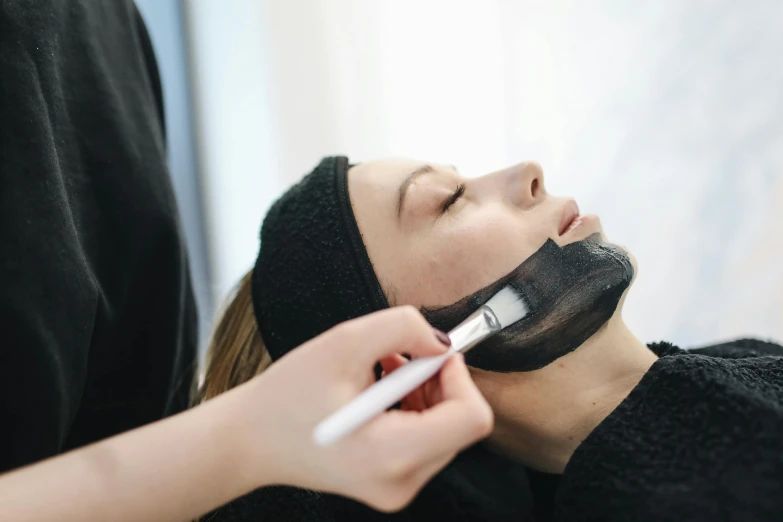 a woman is shaving her face with a pair of scissors, a charcoal drawing, by Emma Andijewska, pexels contest winner, renaissance, face mask, candy treatments, thumbnail, square facial structure